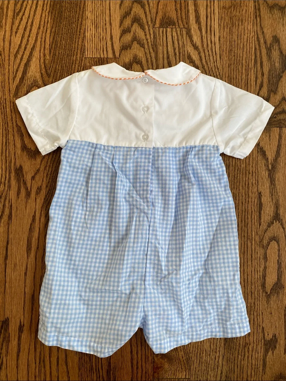 Petit Ami blue and white gingham, pumpkin tractor smocked one piece, size 12M.